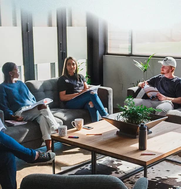 A group of people engaged in a small group facilitation session in a church setting.
